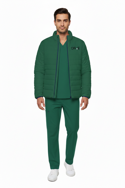A man modeling a matching green scrub set consisting of a zip-up puffer jacket with a black 'DR.E' logo on the chest, a matching green scrub top, and green scrub pants, paired with white sneakers against a plain white background.